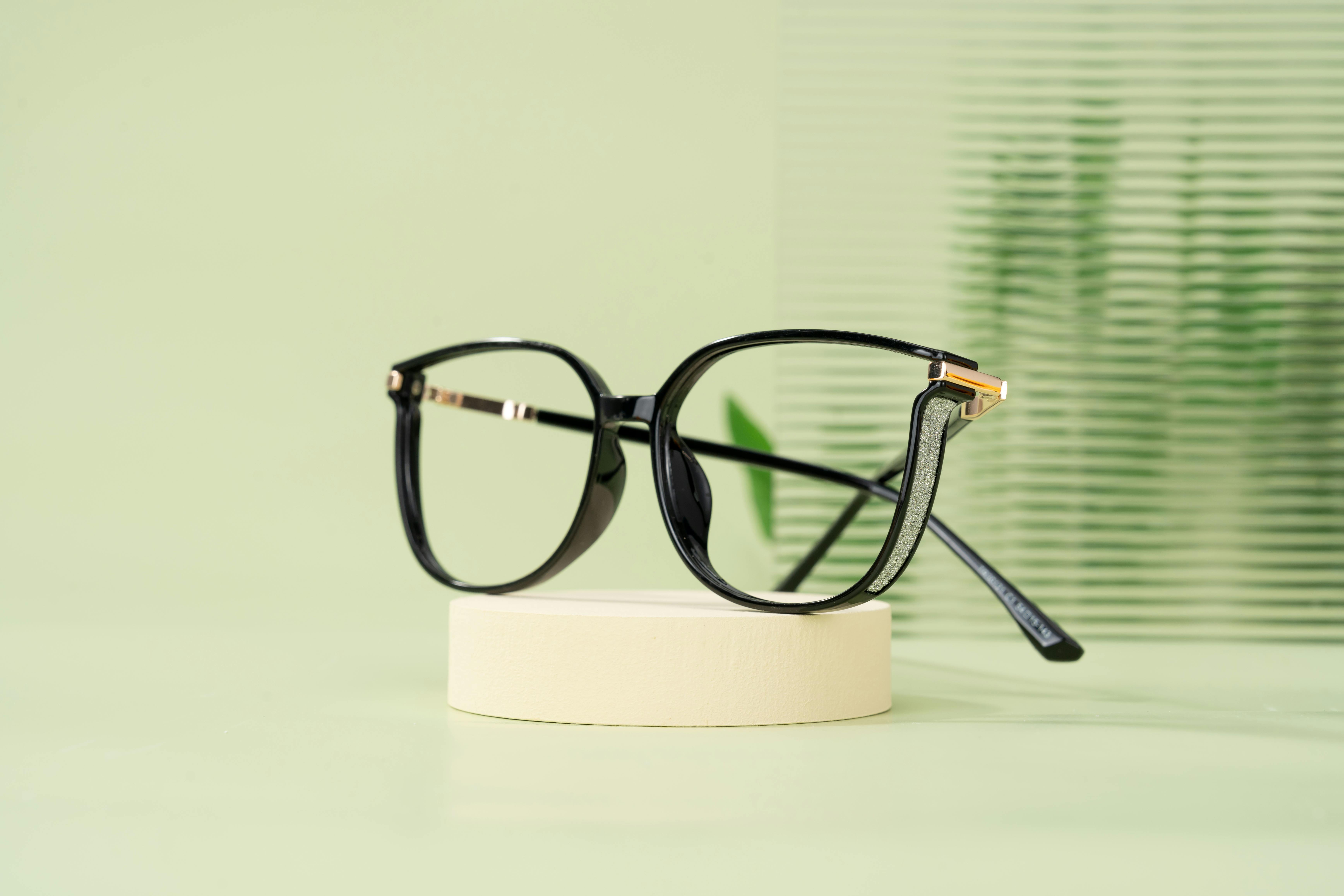 Sleek Black Glasses with Glitter Accents on a Light Base