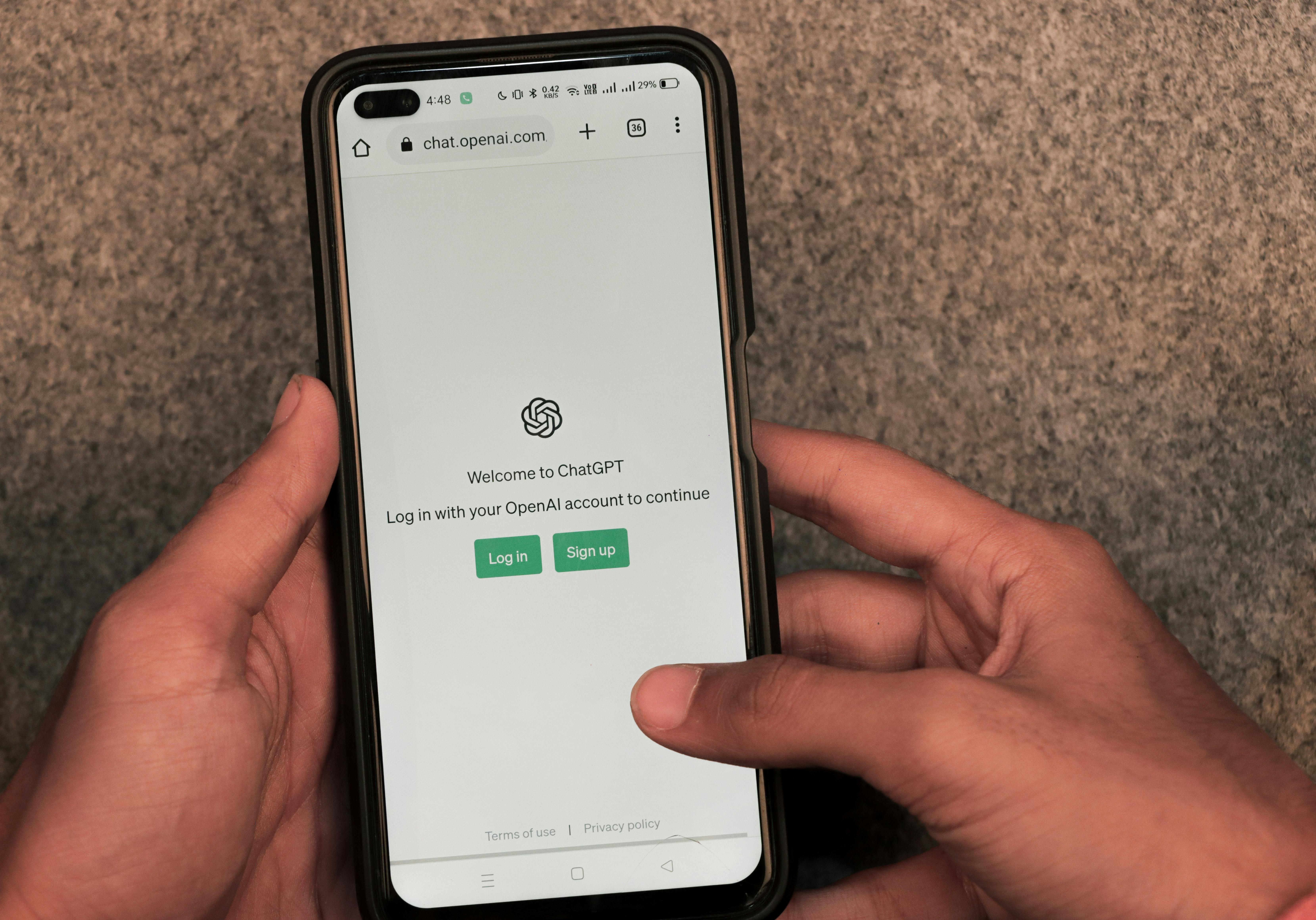 Webpage of ChatGPT, a prototype AI chatbot, is seen on the website of OpenAI, on a smartphone. Examples, capabilities, and limitations are shown.