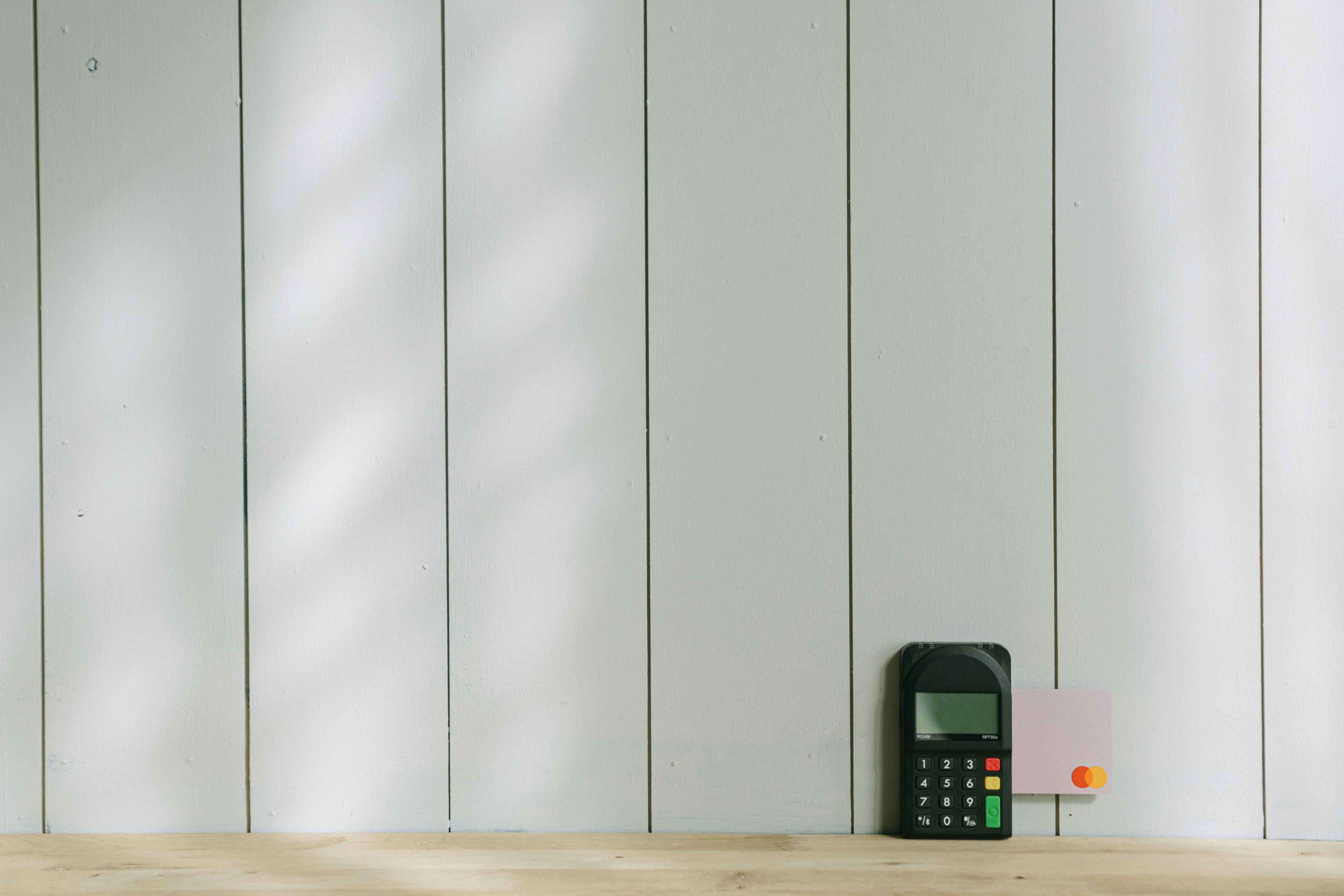 Black and Gray Digital Device on Brown Wooden Table