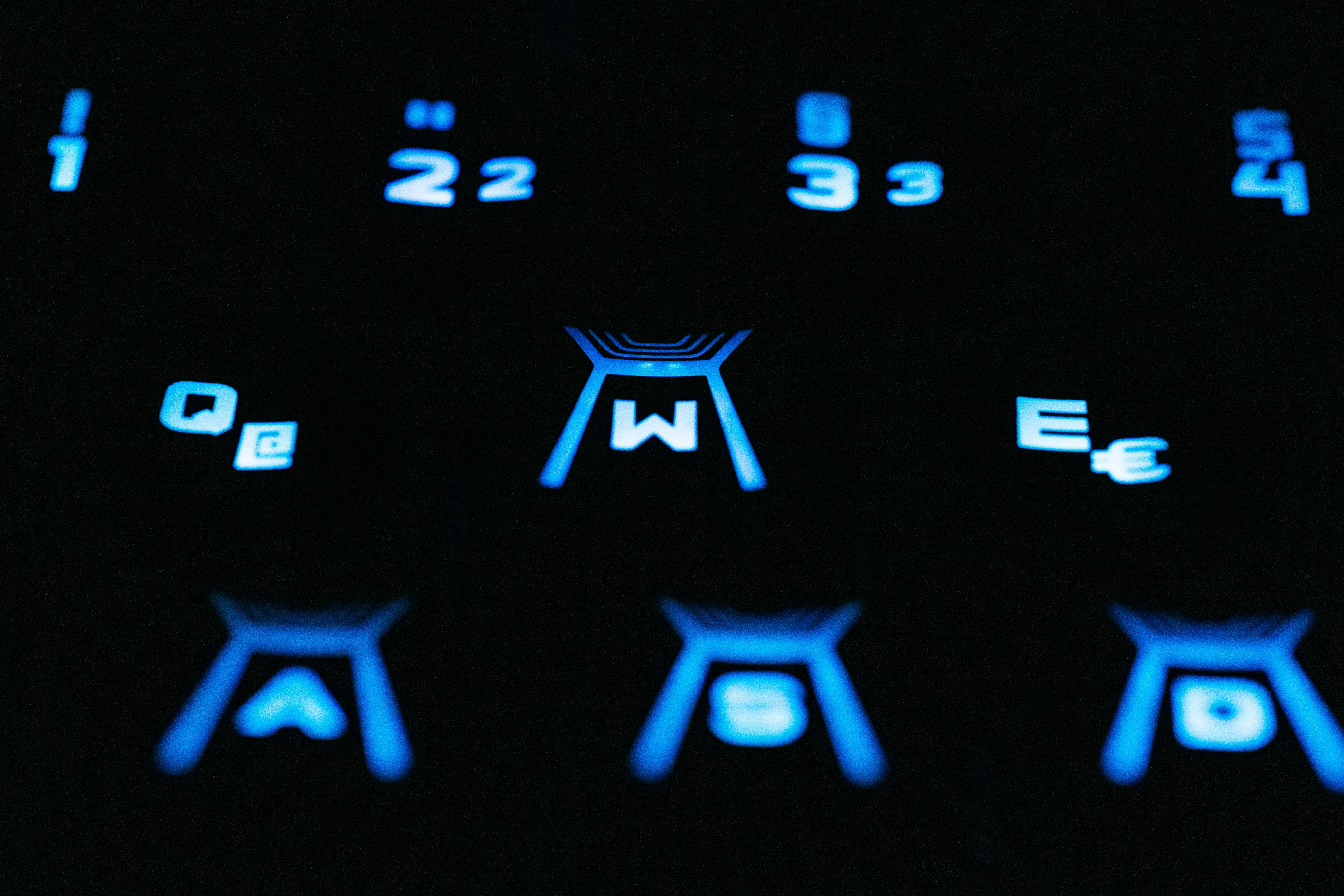 A close up of a keyboard with blue lights