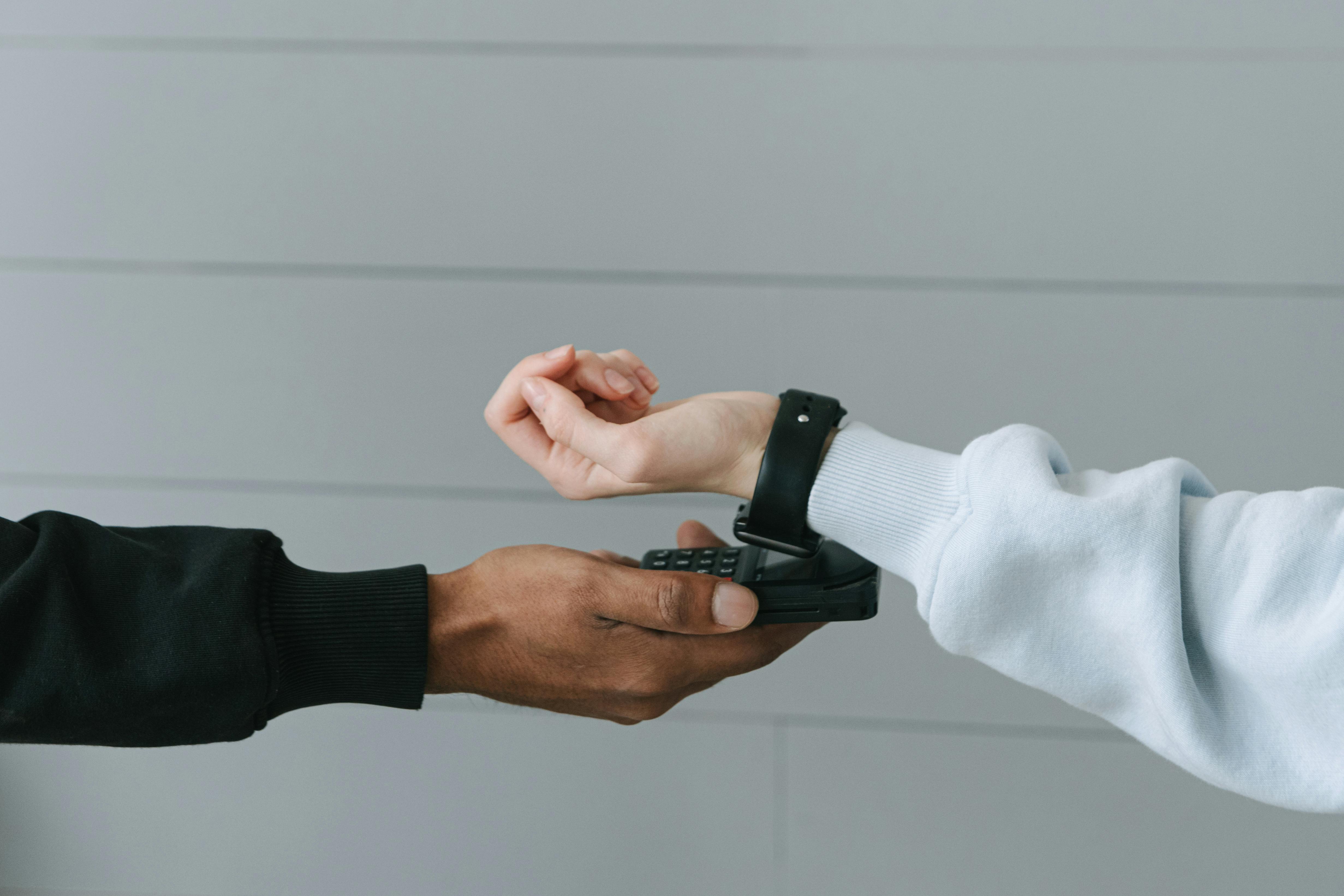 Person Paying Using Her Smartwatch